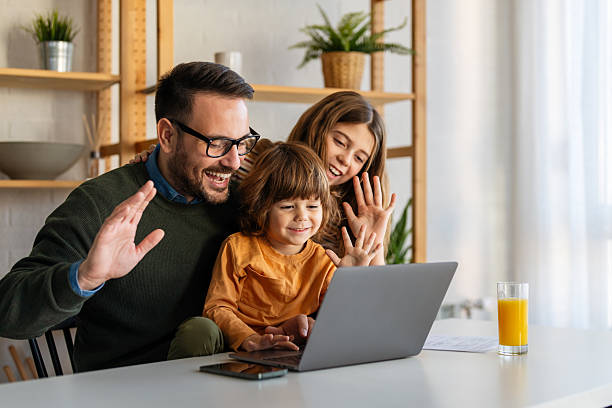 istock Father with kids having fun online with application watching video cartoon or playing game on laptop 2242642959