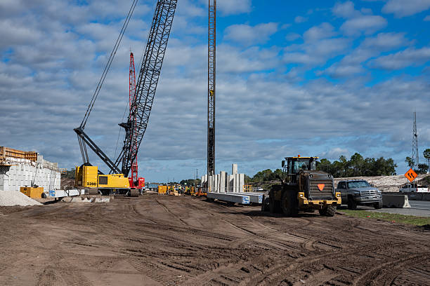 istock highway construction site with large crane and pile driven into ground by vibrating hydraulic hammer 2242644574