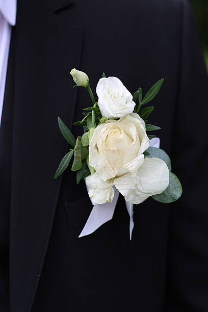 istock Wedding rose boutonniere on the groom's jacket. 2242649083