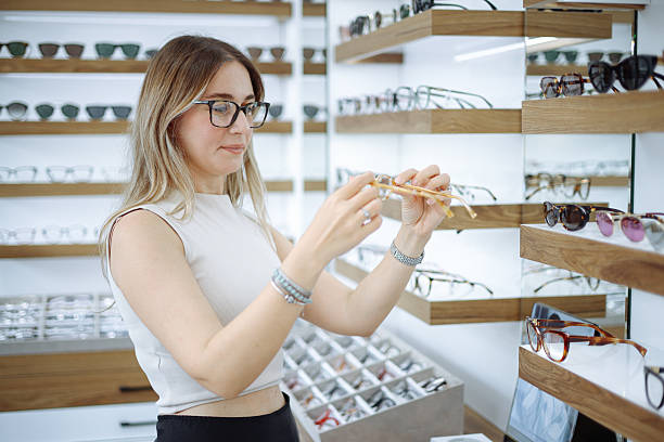 istock Woman selecting eyeglasses in optical store 2242650338