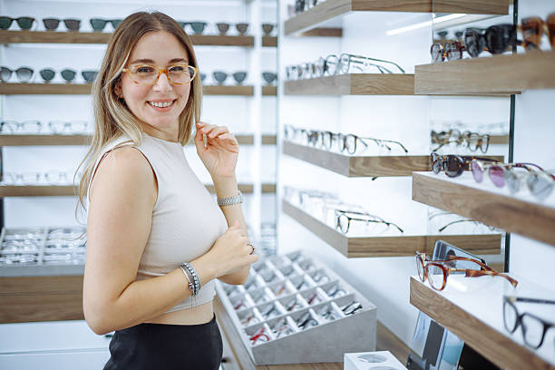 istock Woman selecting eyeglasses in optical store 2242650432