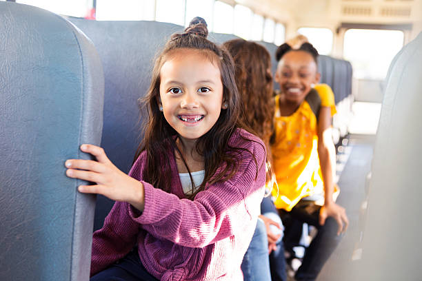 istock Smiling diverse children on a school bus ready for a day of learning and fun. 2242651929
