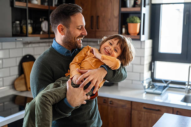 istock Happy loving daddy and affectionate boy playing, laughing having fun at home. Family leisure concept 2242652119