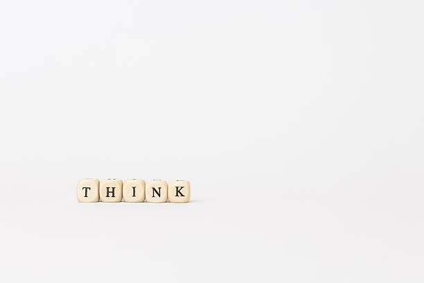 istock Wooden letter blocks spelling THINK on a minimalistic white background, symbolizing creativity and inspiration in thought processes. copy space 2242653982