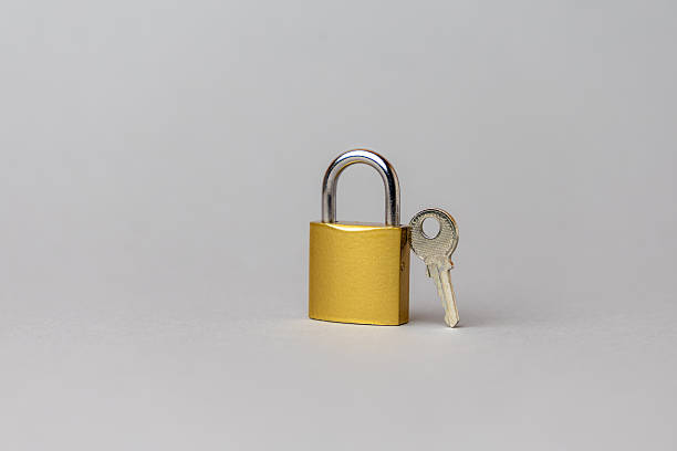 istock Golden padlock with key placed on a neutral background, symbolizing security, protection, and financial technology concepts in modern design. copy space 2242654141