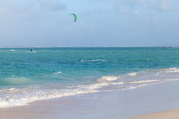 istock Beach scene with a lone kite surfer glides across turquoise waves 2242657010