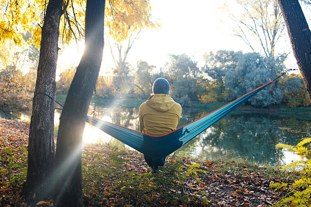 istock Man Resting in a Hammock looking at the river stock photo 2242658196