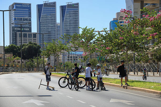 Tel Aviv, Israel -02, October 2025: Empty streets in Tel Aviv during Yom Kipur, when cars disappear and people ride bicycles through the quiet city surrounded by skyscrapers.