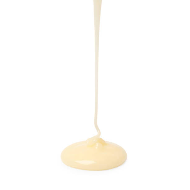 istock Pouring delicious condensed milk isolated on white 2242662867