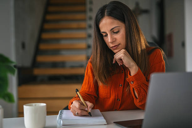 istock Woman studying, writing notes in home office 2242663860
