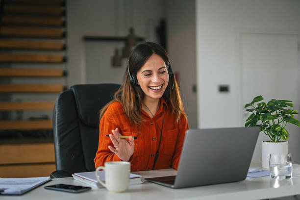 istock Woman video conferencing from home office smiling and working remotely 2242664069
