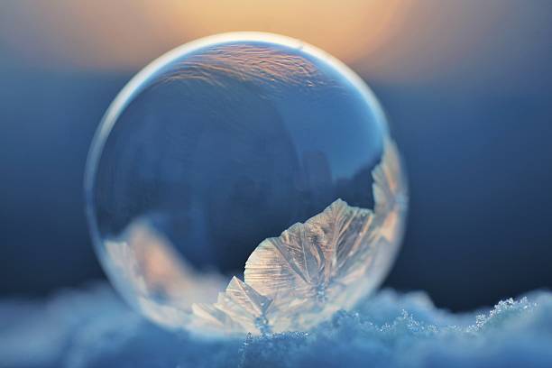 istock A frozen soap bubble displaying intricate ice crystals rests upon sparkling snow under soft, diffused light.Concept of the delicate beauty of fleeting moments. 2242664094