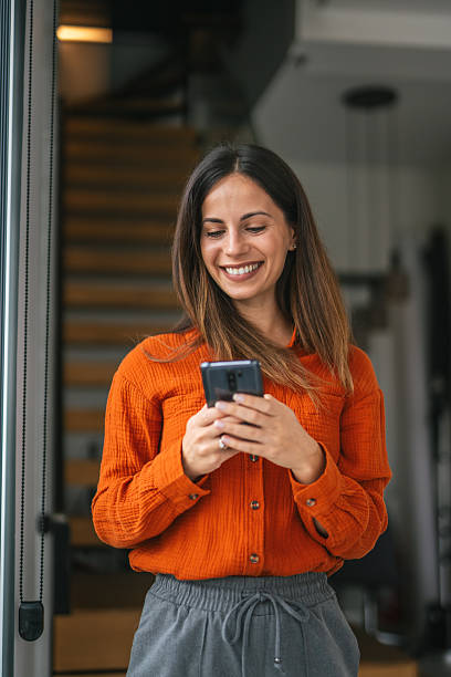 istock Happy woman smiling looking camera holding smart phone 2242664149