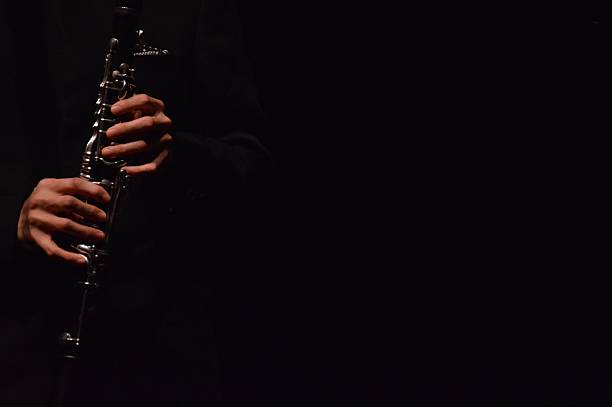 istock Hands Holding Clarinet on Black Background 2242664853