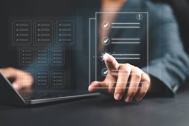 istock Businessmen review procedures through documents containing checkbox lists, rules of conduct concepts, rules and policies, company regulatory documents, terms and conditions. 2242670591