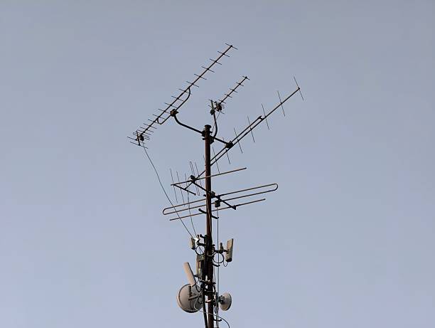 rusty mast and antennas on urban rooftop evoke nostalgic broadcast and connection themes