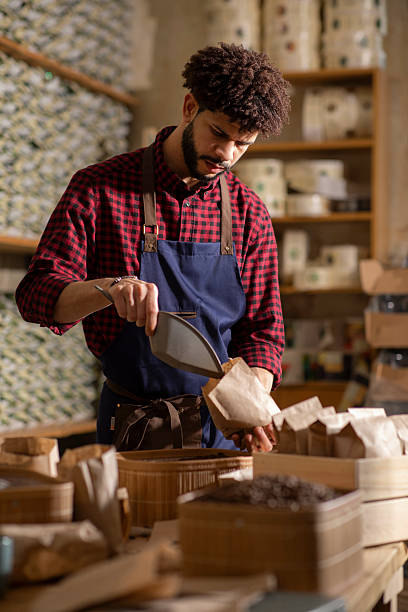 istock Man Preparing Packaged Goods in an Artisan Store with Focused Expressions 2242674671