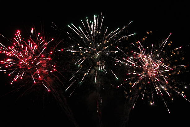 istock Red and golden firework explosions in the night sky. 2242675798