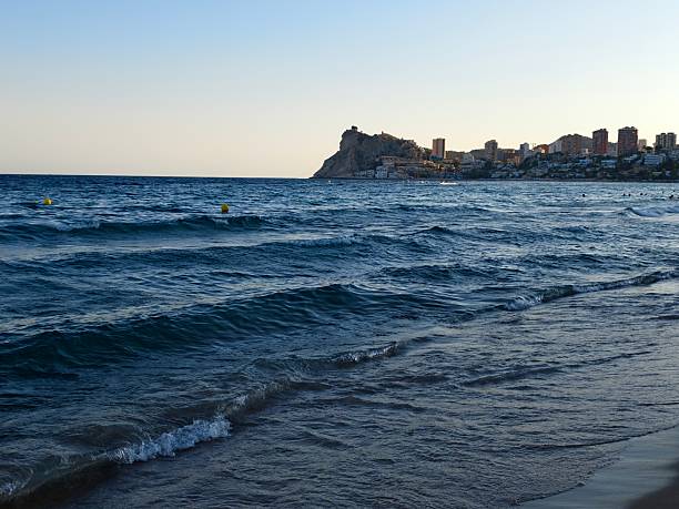 serene coastal evening scene, gentle waves and pastel sky create peaceful seaside ambiance