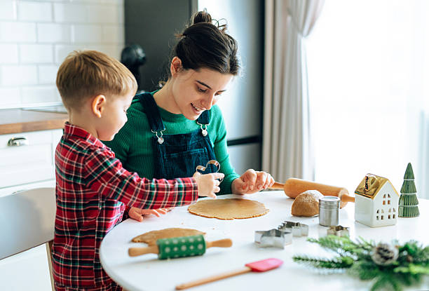 istock Mom and Son Preparing Christmas Cookie Dough 2242679538