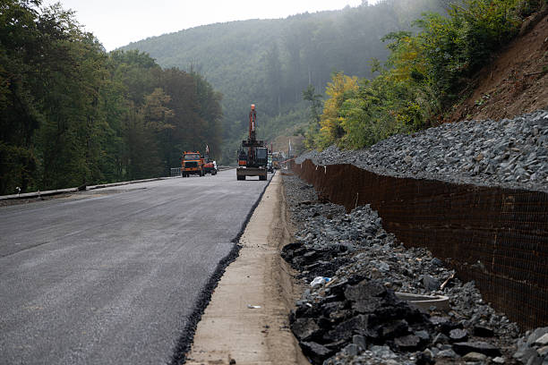 istock Asphalt paving and retaining wall on mountain road construction 2242679657