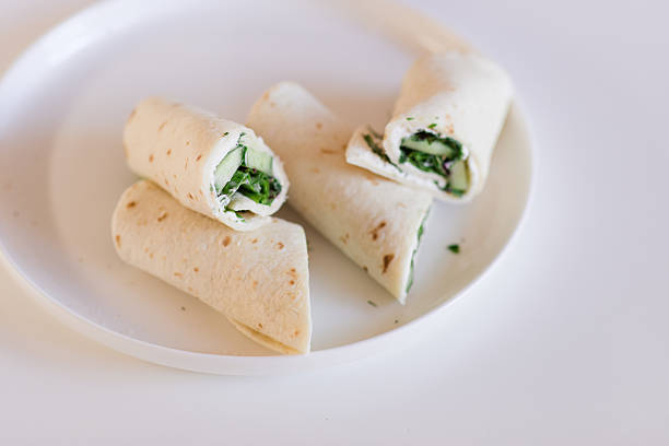 Refreshing Cucumber, Dill & Cream Cheese Wraps on a White Plate and Table