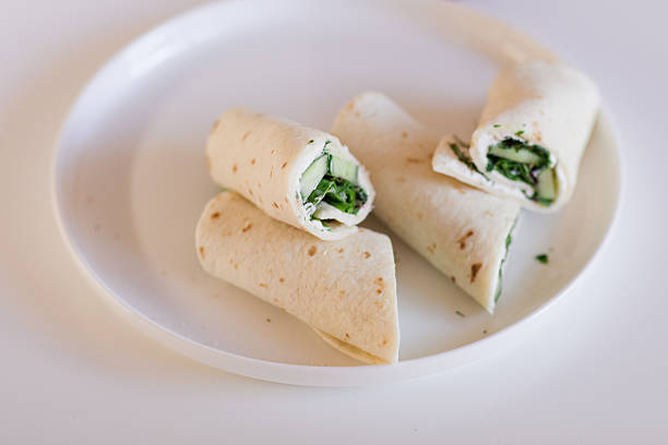 Refreshing Cucumber, Dill & Cream Cheese Wraps on a White Plate and Table