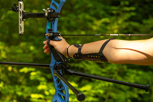 istock Caucasian Female Teenage Archer Practicing with Bow and Arrow in Forest Setting 2242687176