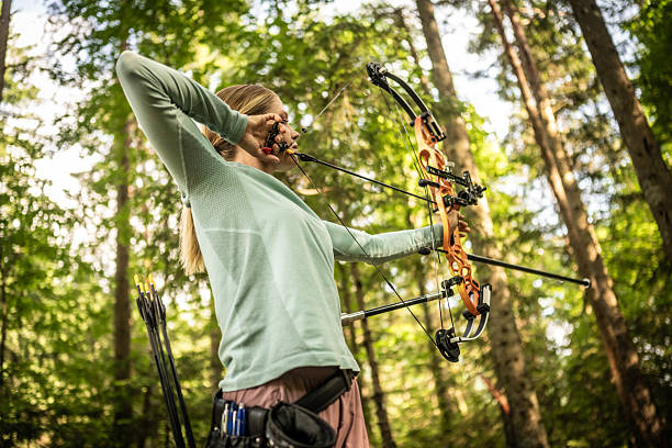 istock Young Caucasian Female Concentrating on Archery in Forest Setting 2242687212