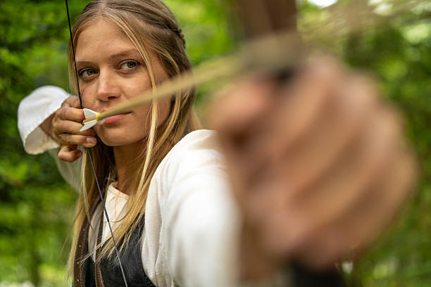 istock Caucasian Female Archer Practicing in Woodland Environment 2242687245