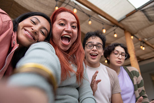 istock group of diverse gen z friends taking a group selfie 2242692863