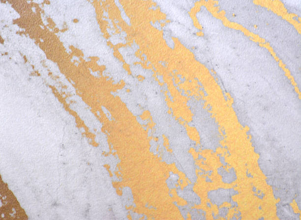 Light gray marble with wide golden veins, seamless background with a natural stone pattern close-up. Background, texture.