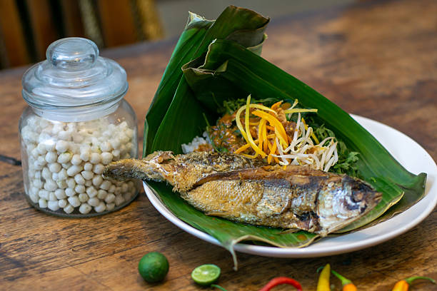 istock Authentic Indonesian Pecel with Fried Fish on Banana Leaf, Traditional Javanese Cuisine 2242698549