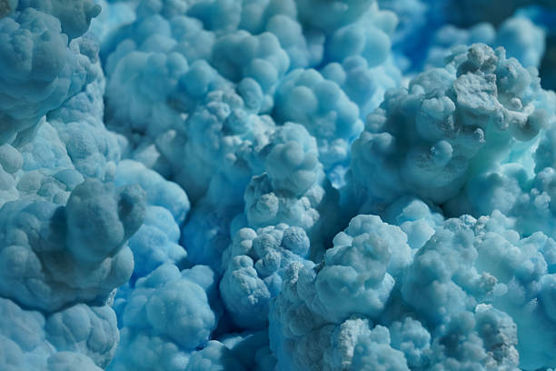 Close-up photograph of a natural blue aragonite mineral specimen showcasing its distinctive pale blue to turquoise coloration and characteristic crystal structure. Aragonite is a calcium carbonate mineral that often forms in clusters, stalactites, or radiating needle-like formations. This specimen displays the soft, calming blue hues that make blue aragonite popular among mineral collectors and crystal enthusiasts. The stone's natural texture and color variations are clearly visible. Blue aragonite is valued for its aesthetic beauty and is commonly used in mineral collections, metaphysical practices, and decorative purposes. Perfect for concepts related to geology, mineralogy, natural crystals, earth science, gemstones, healing stones, mineral collecting, and natural history.