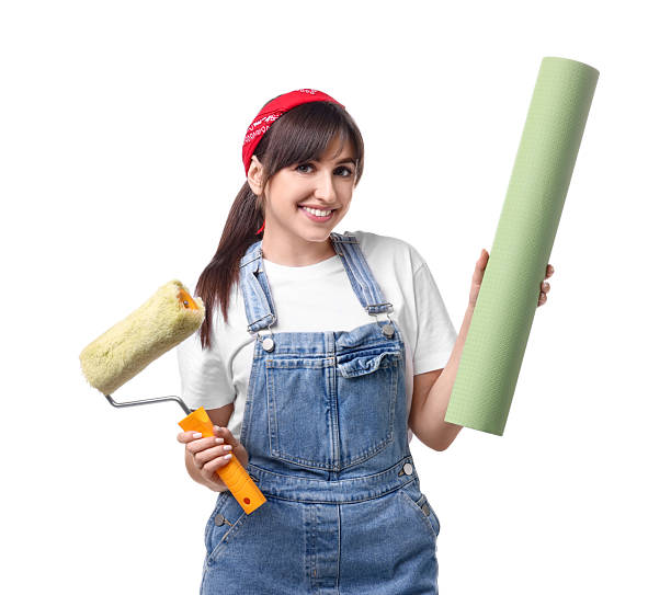 istock Beautiful woman with wallpaper roll and roller on white background 2242708197