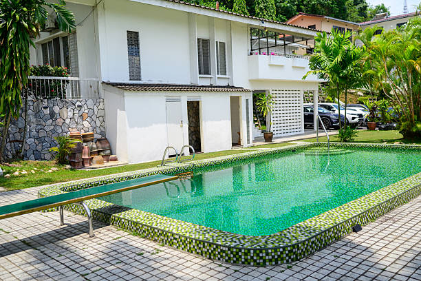 istock Tropical house with pool, embraced by vibrant greenery 2242709192