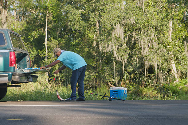 istock Man with Freshly Caught Fish in the Bayou 2242710228