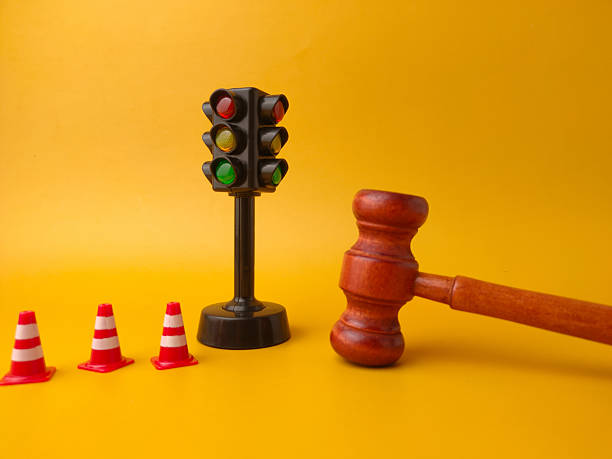 istock The image shows a miniature traffic light, small traffic cones, and a gavel. This combination of objects can be interpreted as a representation of traffic law and its enforcement 2242715527