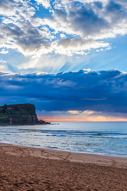 istock Winter sunrise by the sea shore with rain clouds 2242715727