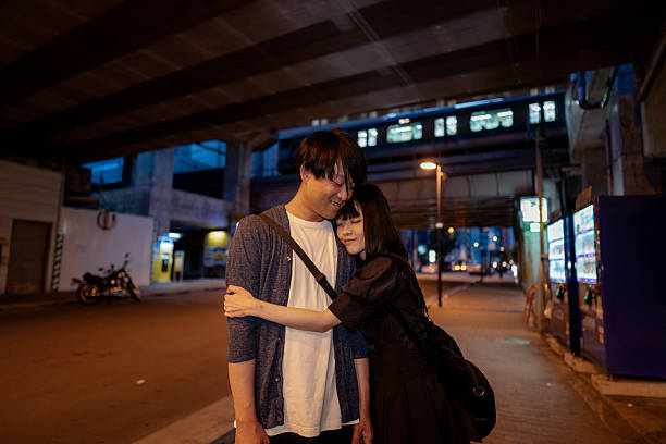 istock Couple embracing on street at sunset time 2242719126