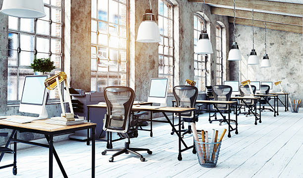 istock 3d rendering of a modern industrial office. Empty loft workspace with desks in bright sunlight 2242719204