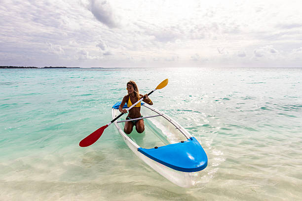 istock Young happy woman having fun while paddling at sea. 2242719342