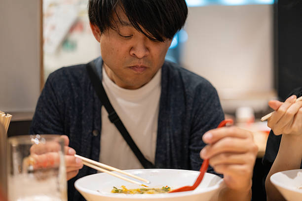 istock Man eating ramen with his girlfriend at ramen shop 2242719344