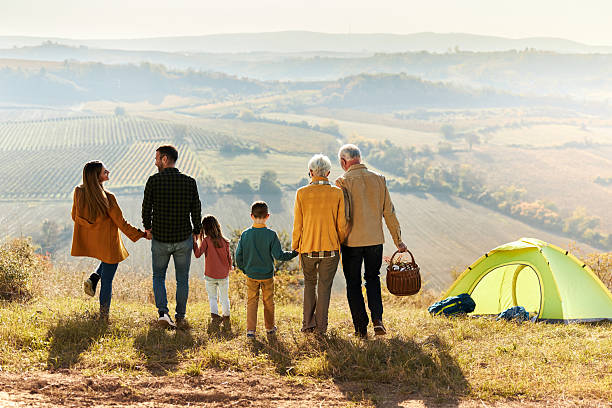 istock Back view of extended family going on camping on a hill. 2242720424