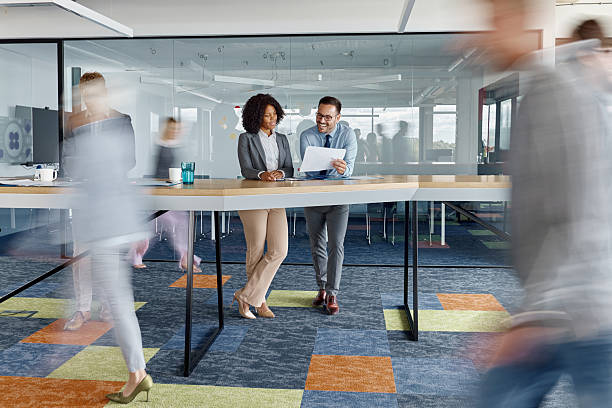 istock Business people working on reports among colleagues in blurred motion. 2242720579
