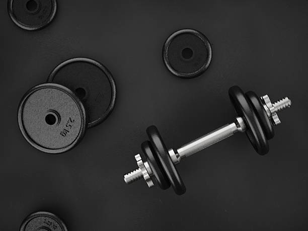 istock Dumbbell with Weight Plates on Dark Floor, Top View 2242721577