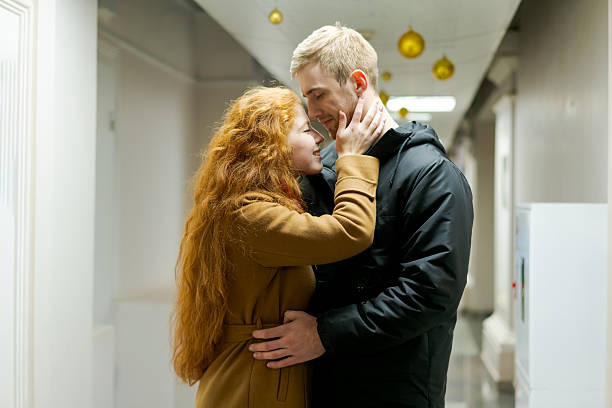 istock Man and a woman are hugging in a hallway 2242721695