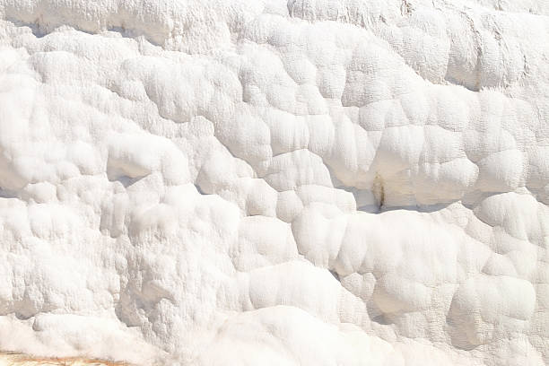 istock White rock wall with a lot of bumps and ridges 2242724607