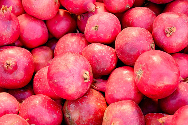 istock Pile of red fruit, including pomegranates 2242724634