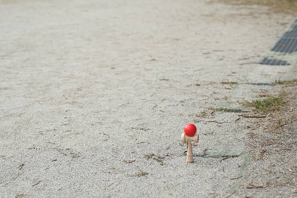 istock A red ball is sitting on a patch of dirt 2242725012
